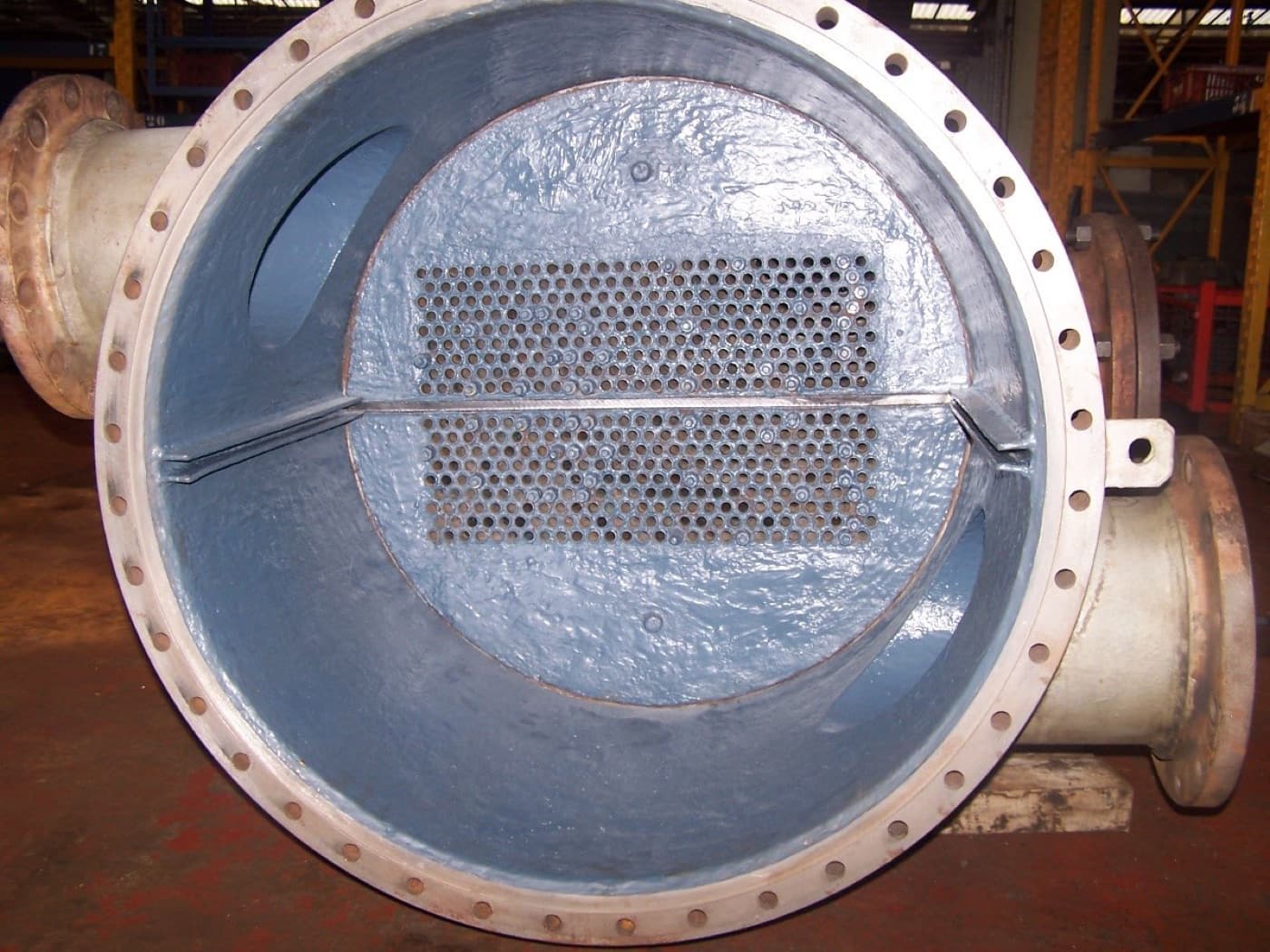 Heat exchanger channel head opened to show the tube sheet and pass partition, the water box interior coated pale blue-gray