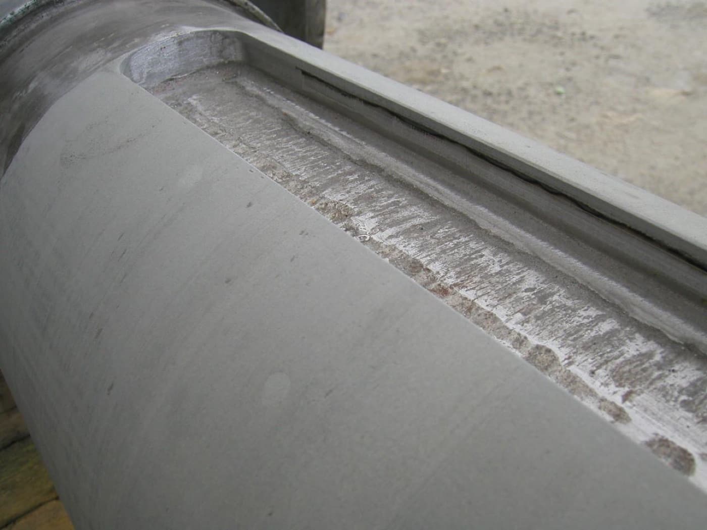 Machined shaft with a keyway, a rebuilt band of weld and filler visible along its shoulder